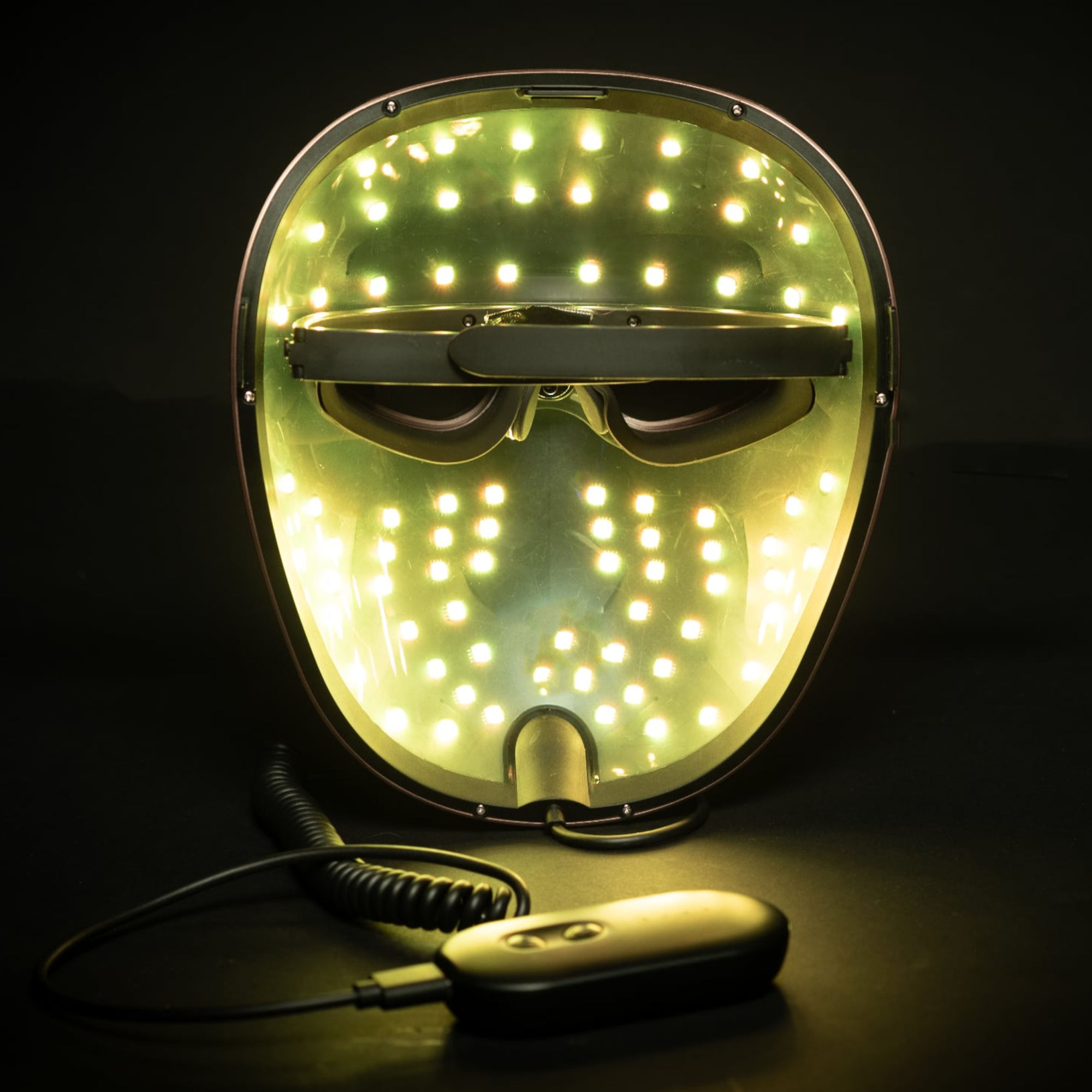 picture demonstrates the mask from the inside with the yellow led colour setting on with the controller nearby
