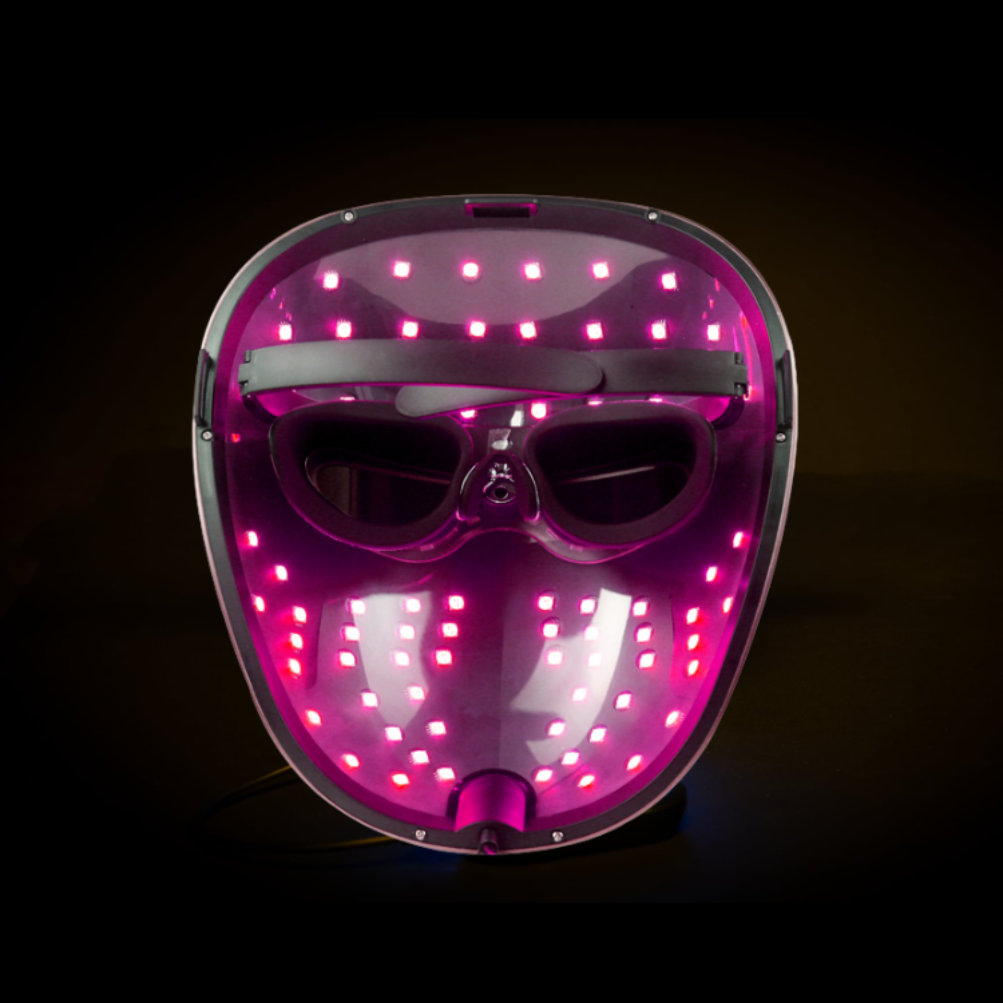 picture demonstrates the mask from the inside with the pink led colour setting on with the controller nearby