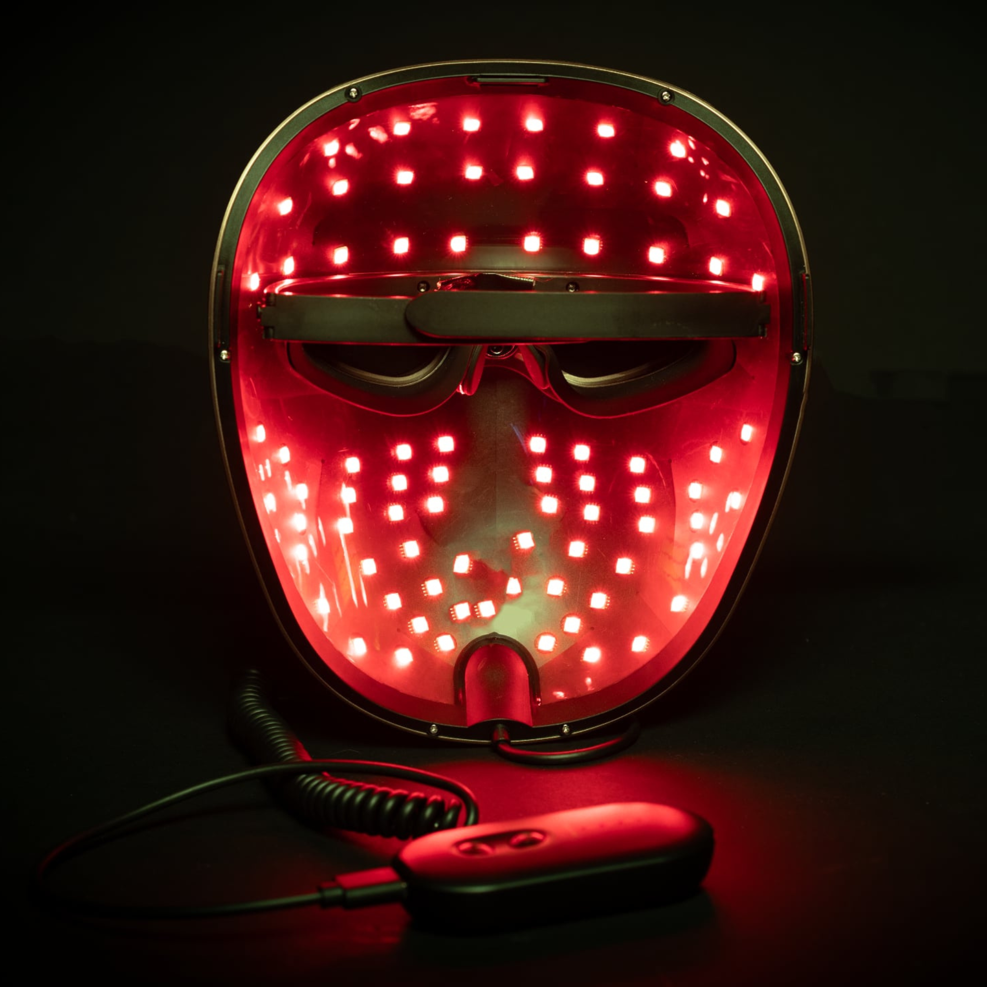picture demonstrates the mask from the inside with the red and mixed near infrared led colour setting on with the controller nearby